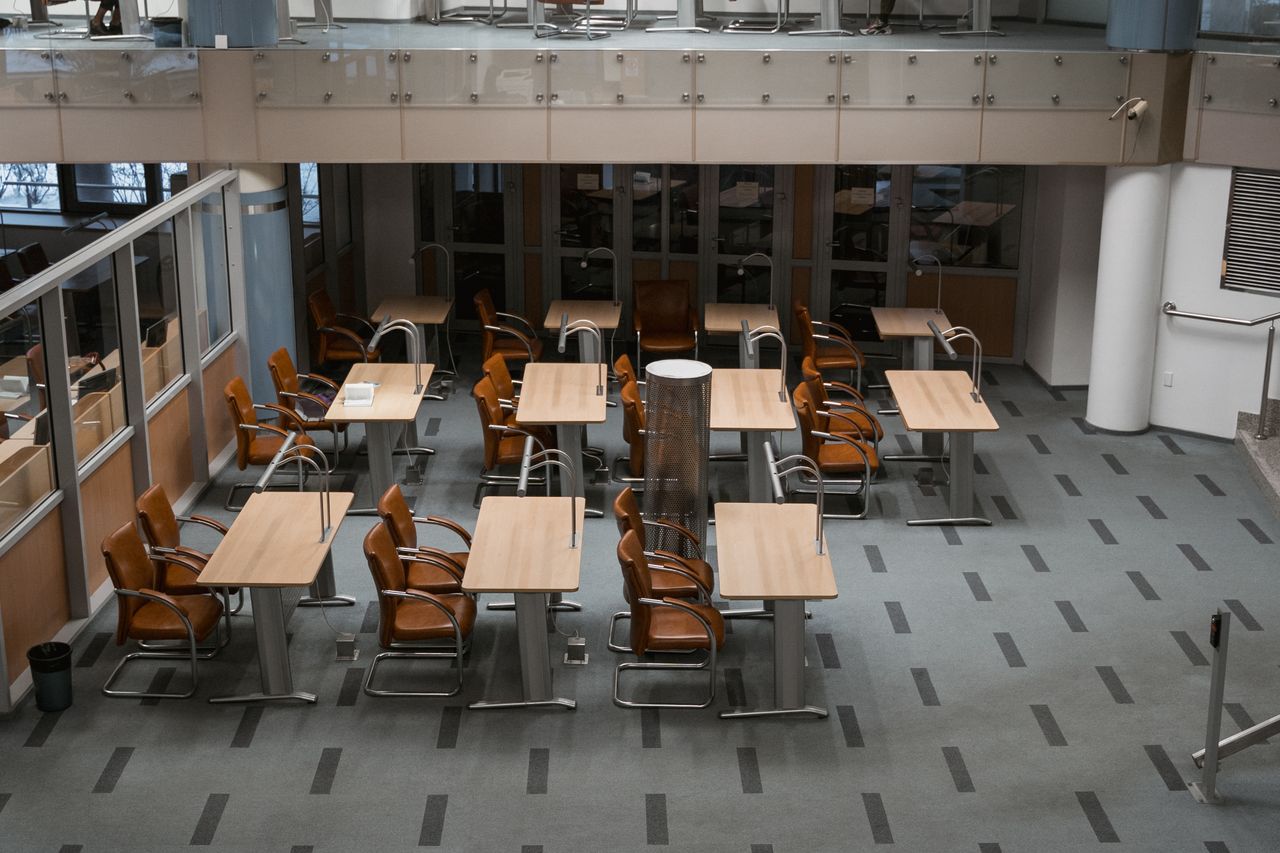Bright, modern office interior with arranged chairs and tables, ideal for workspaces.